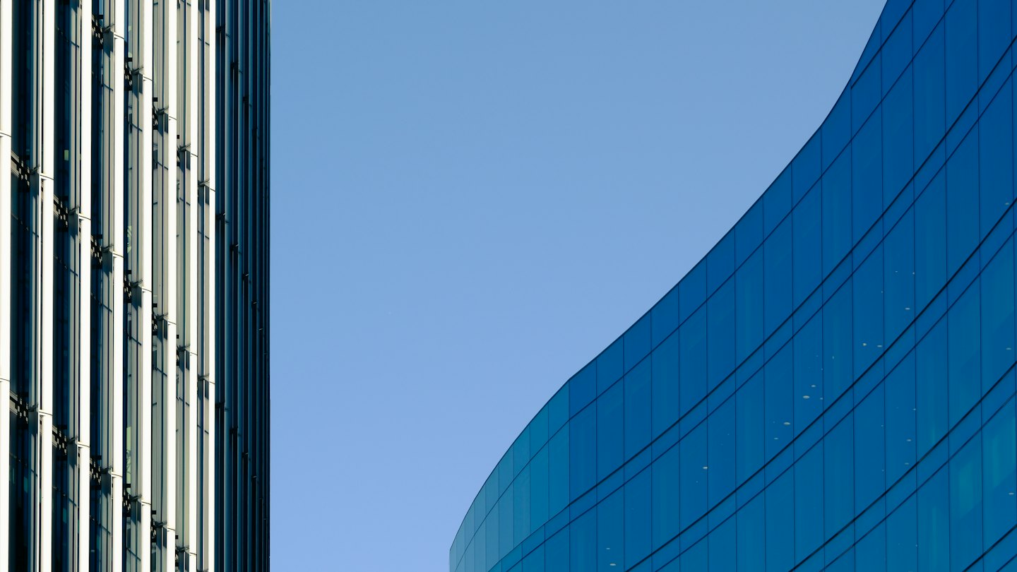 Two modern buildings with distinct geometric architectural facades.